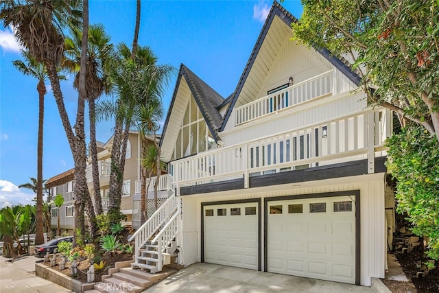 view of front of home featuring stairs, driveway, and an attached garage