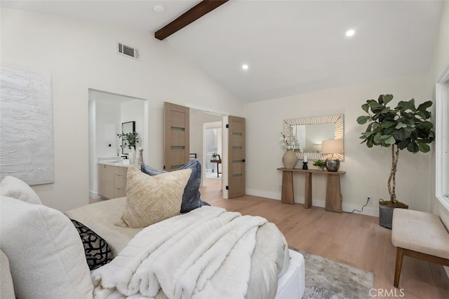 bedroom with recessed lighting, visible vents, ensuite bathroom, light wood-style floors, and beamed ceiling