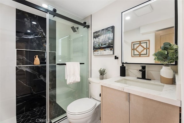 full bath featuring a stall shower, vanity, and toilet