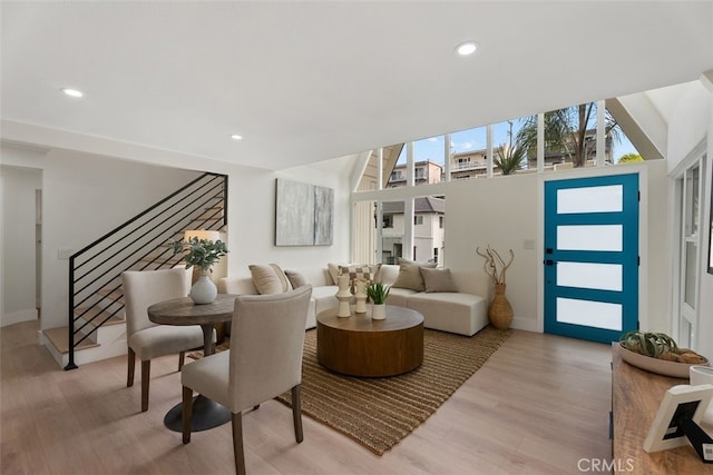 dining room with stairway, recessed lighting, and light wood-style floors