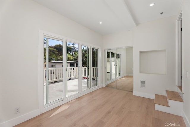 unfurnished room with light wood-style floors, visible vents, and recessed lighting