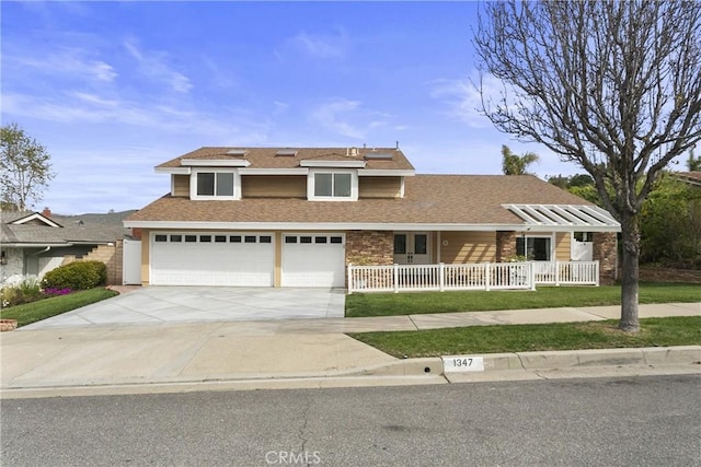 view of front of property with a shingled roof, concrete driveway, fence, and an attached garage