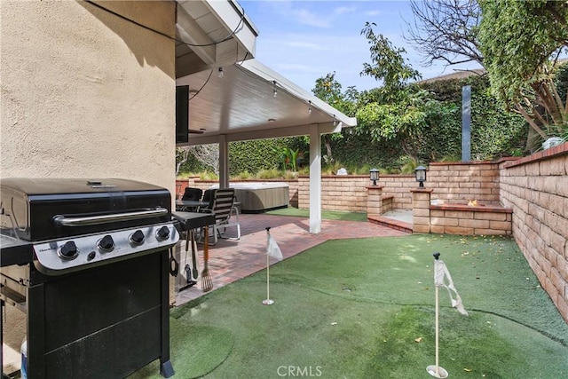 view of patio with a grill and fence