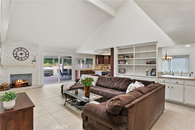 living room with light tile patterned flooring, a fireplace, beam ceiling, and an inviting chandelier