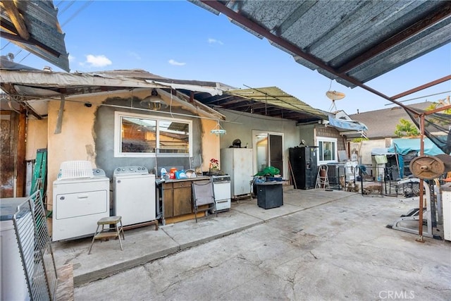 view of patio with independent washer and dryer