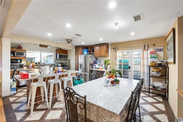 dining space with french doors, a ceiling fan, visible vents, and recessed lighting