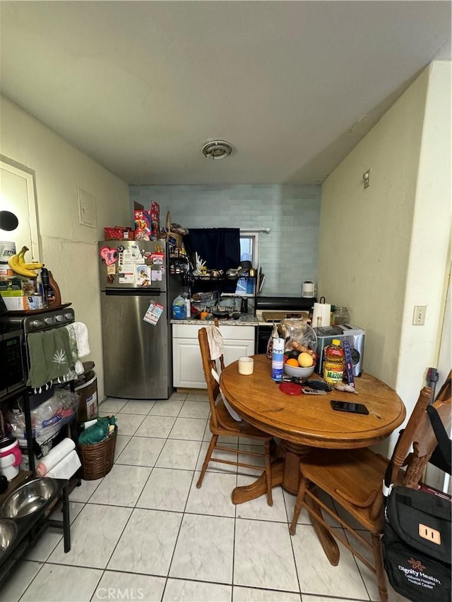 dining space with light tile patterned flooring and visible vents