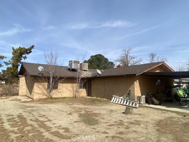 3158 E E Ave H8, Lancaster, CA 93535 - rear view of house featuring stucco siding and a carport