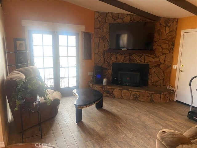 3158 E E Ave H8, Lancaster, CA 93535 - living room with wood finished floors, vaulted ceiling, and a stone fireplace