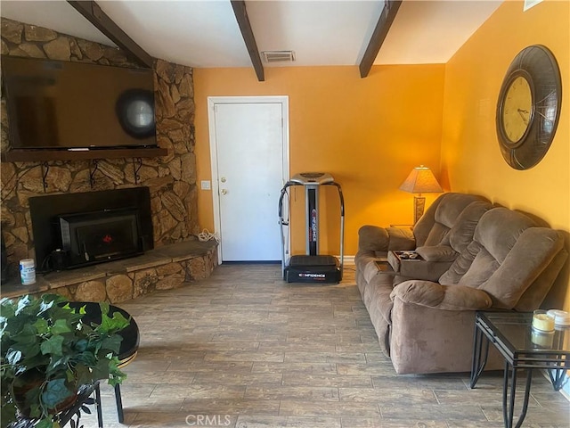3158 E E Ave H8, Lancaster, CA 93535 - living area featuring beam ceiling, wood finished floors, and a stone fireplace