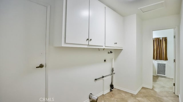 clothes washing area with visible vents, baseboards, cabinet space, electric dryer hookup, and attic access