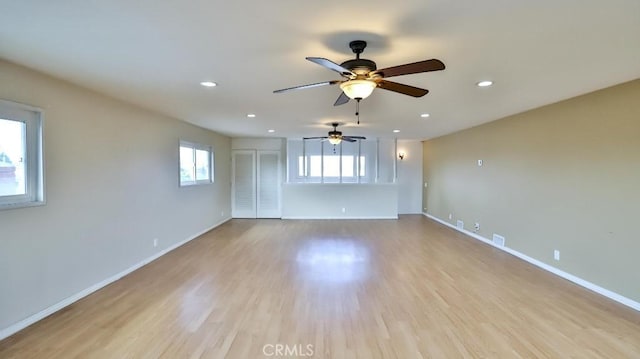 unfurnished room featuring visible vents, baseboards, wood finished floors, and recessed lighting