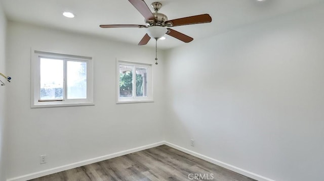 empty room with ceiling fan, baseboards, wood finished floors, and recessed lighting