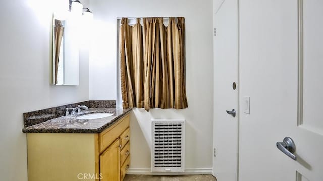 bathroom featuring baseboards, visible vents, and vanity