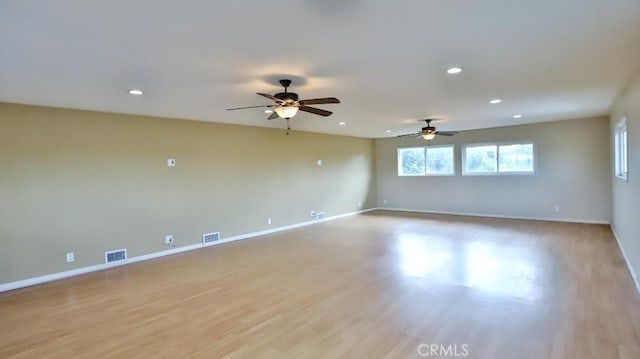 unfurnished room featuring light wood finished floors, baseboards, visible vents, and recessed lighting