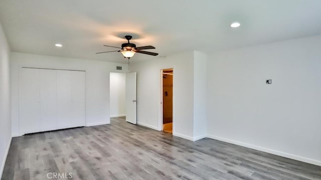 unfurnished bedroom featuring recessed lighting, a closet, ceiling fan, wood finished floors, and baseboards