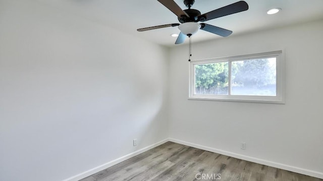 spare room with ceiling fan, recessed lighting, wood finished floors, and baseboards