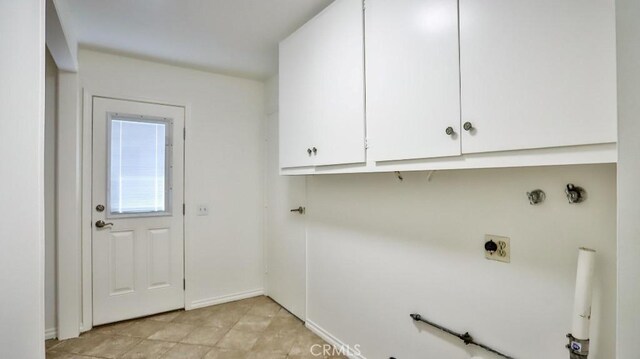 clothes washing area with cabinet space and electric dryer hookup