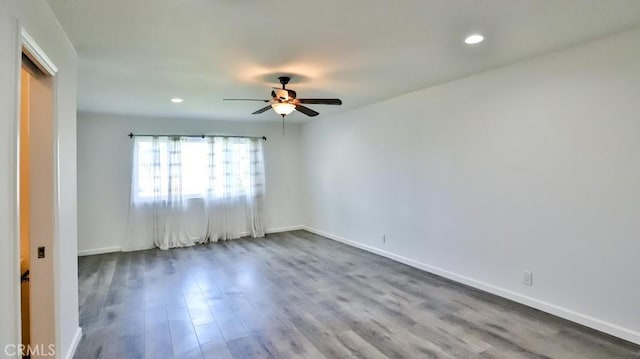 unfurnished room featuring dark wood-type flooring, recessed lighting, ceiling fan, and baseboards