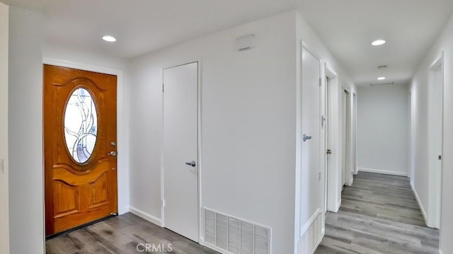 entrance foyer with baseboards, wood finished floors, visible vents, and recessed lighting