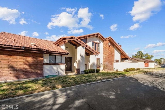 view of front of property with a tiled roof and stucco siding