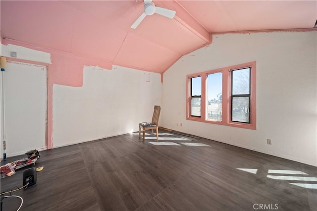 additional living space with lofted ceiling with beams, ceiling fan, and wood finished floors