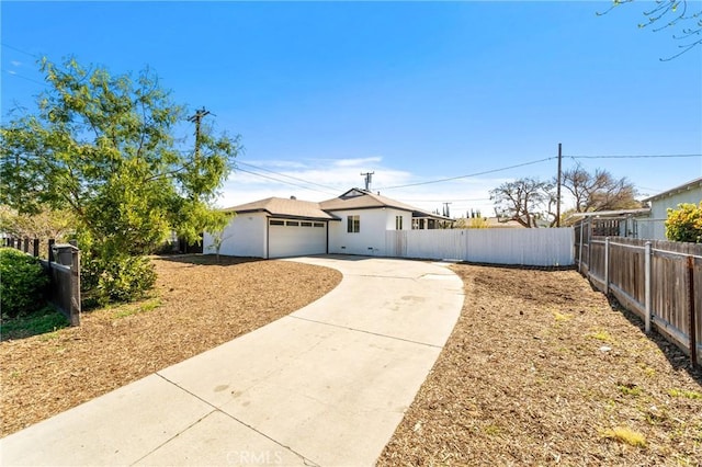 view of front of home featuring driveway and fence