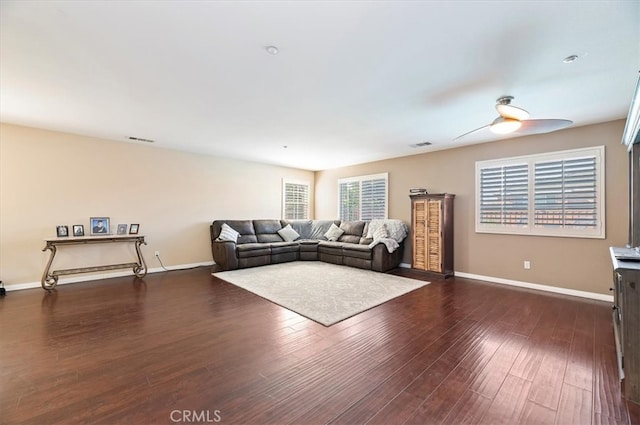 living room featuring baseboards, visible vents, and dark wood-type flooring