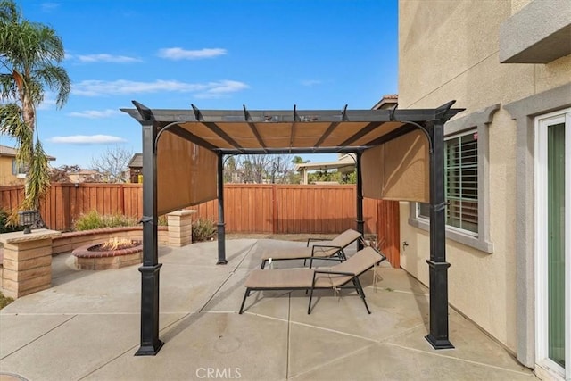 view of patio with an outdoor fire pit, a fenced backyard, and a pergola