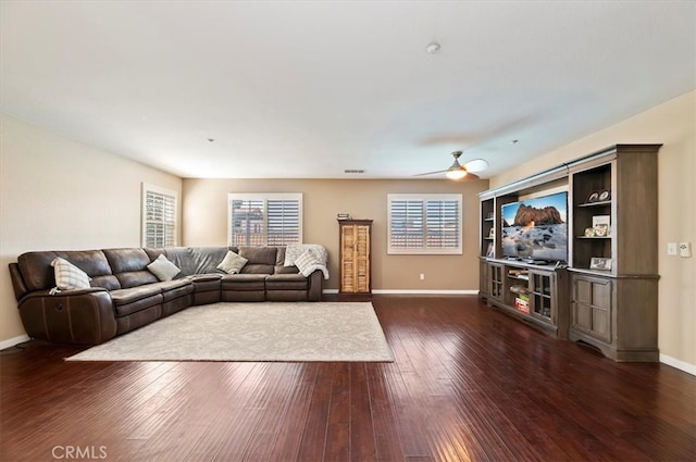 living room featuring ceiling fan, dark wood finished floors, and baseboards