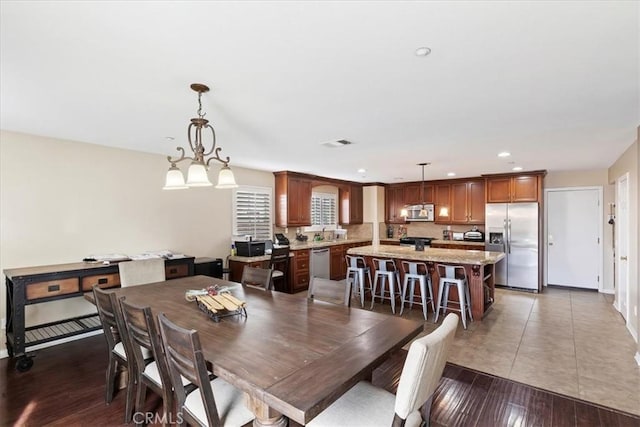 dining room featuring recessed lighting, visible vents, baseboards, and wood finished floors