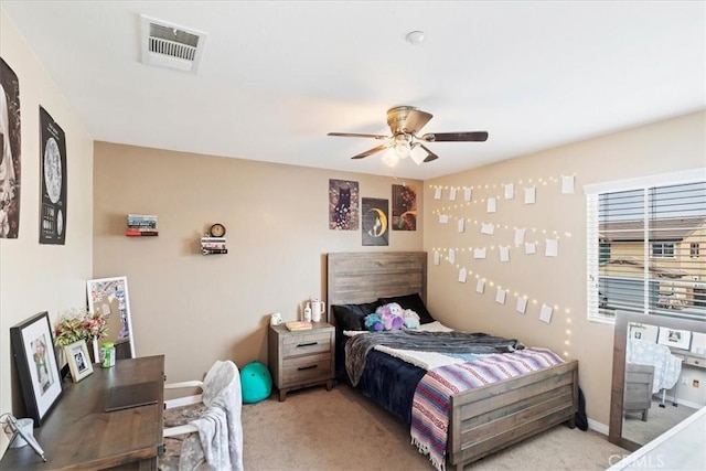 bedroom with light colored carpet, visible vents, ceiling fan, and baseboards