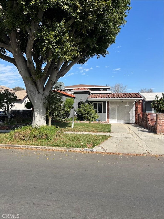 view of front of house with driveway and a tiled roof