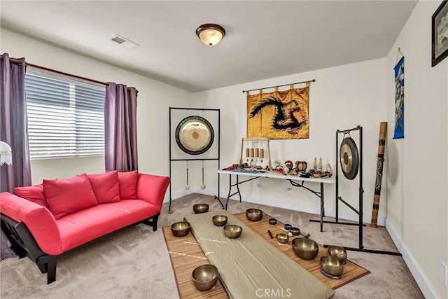 interior space featuring baseboards, visible vents, and carpet flooring