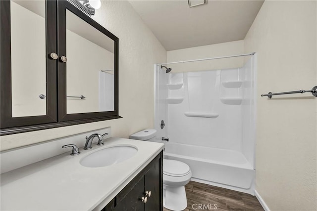 bathroom with vanity, tub / shower combination, wood finished floors, and toilet