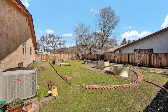 view of yard featuring a vegetable garden, central AC unit, and a fenced backyard