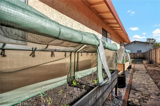 exterior details with a fenced backyard and a vegetable garden