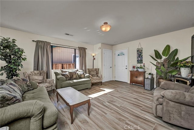 living area with visible vents and light wood finished floors