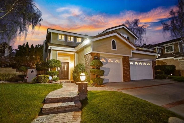 view of front of house with driveway, brick siding, and a lawn