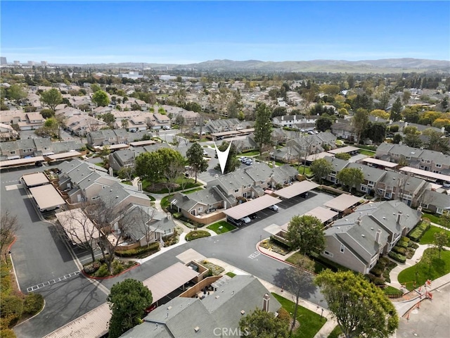 drone / aerial view featuring a residential view and a mountain view