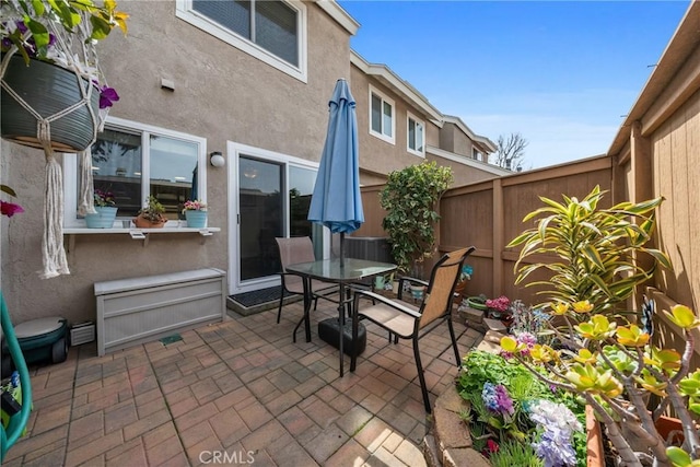 view of patio with outdoor dining area and fence