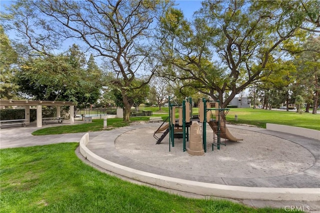 community playground featuring a pergola and a lawn