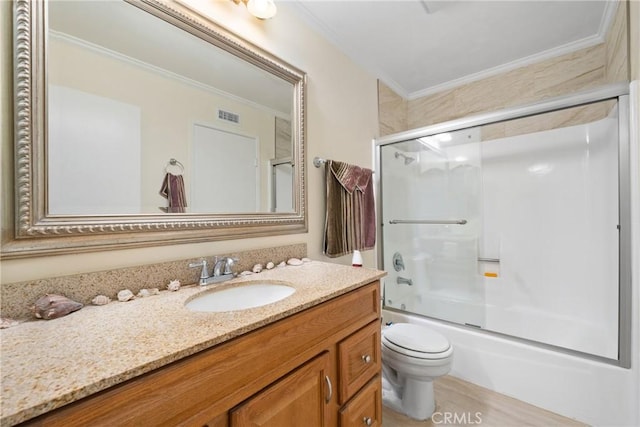 bathroom featuring toilet, shower / bath combination with glass door, visible vents, vanity, and ornamental molding