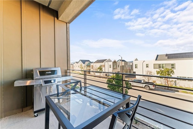 balcony with a residential view and area for grilling