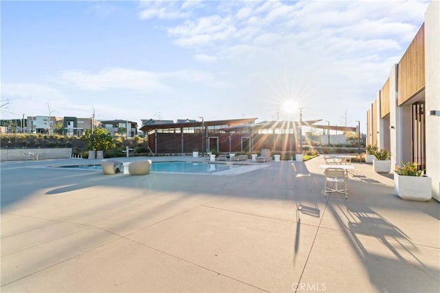 community pool with a patio area