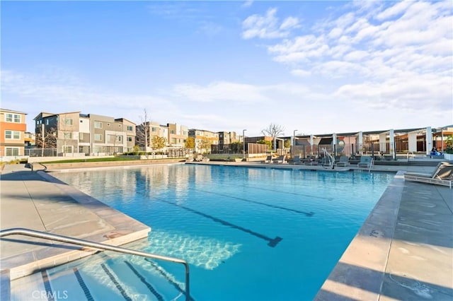 view of swimming pool with a residential view