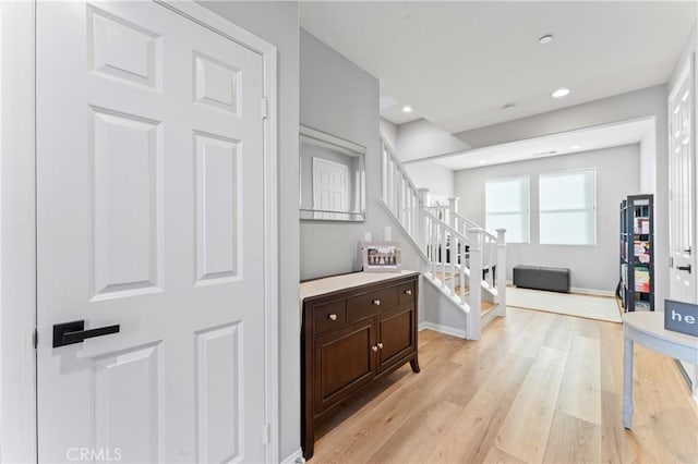 interior space with baseboards, wood finished floors, and recessed lighting