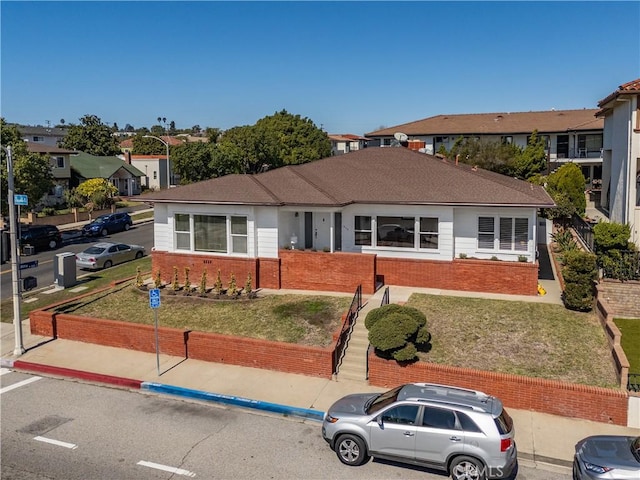 single story home with a front lawn and brick siding