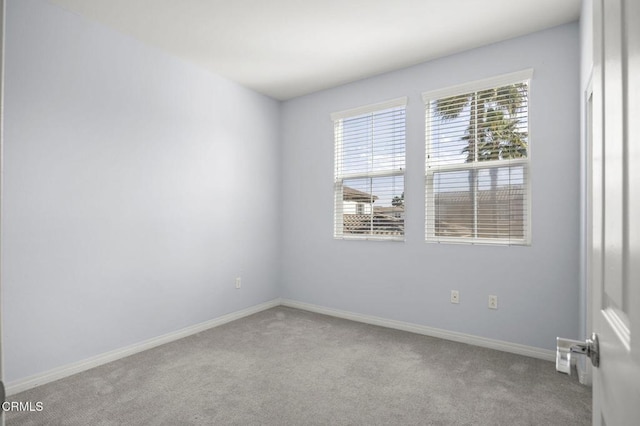 unfurnished room featuring carpet flooring and baseboards