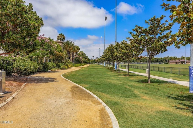 view of property's community featuring fence and a yard